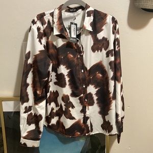 Brown and white cow print polyester button down shirt with waist sash.